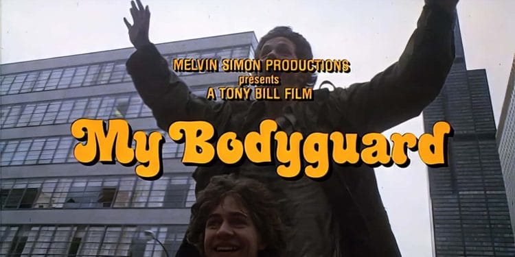 Scene from the 80s movie "My Bodyguard" showing the title and credits against a cityscape background.