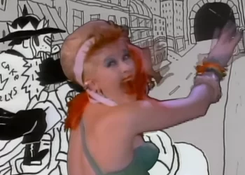Cindy Lauper in colorful outfit dancing with cartoon background