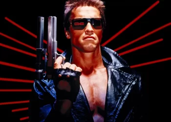 Man in leather jacket with sunglasses and shotgun.