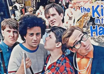 Comedy group posing outdoors with logo.