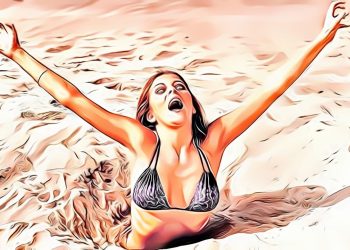 Woman in black bikini arms raised, sandy background.