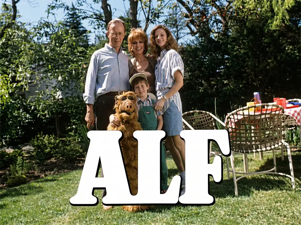 ALF standing with the Tanner family in their backyard from the 1986 television sitcom ALF.