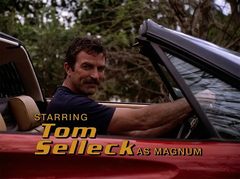 Tom Selleck as Thomas Magnum sitting in a red Ferrari convertible in the opening credits of the 1980 TV series Magnum, P.I.